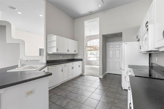 81 Brownstone Ln, Palm Coast, FL 32137 - kitchen featuring white appliances, dark countertops, open shelves, white cabinets, and tile patterned flooring