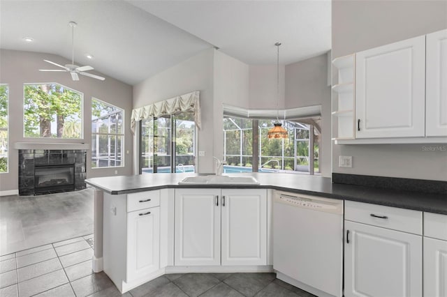 81 Brownstone Ln, Palm Coast, FL 32137 - kitchen featuring white dishwasher, ceiling fan, a fireplace, a peninsula, and open floor plan