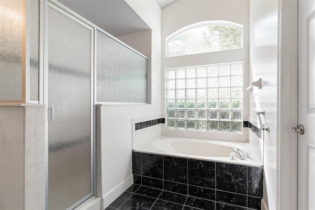 81 Brownstone Ln, Palm Coast, FL 32137 - bathroom with a stall shower, a bath, plenty of natural light, and tile patterned flooring