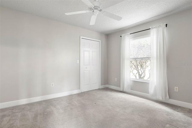 81 Brownstone Ln, Palm Coast, FL 32137 - unfurnished bedroom with carpet, a textured ceiling, a closet, and a ceiling fan