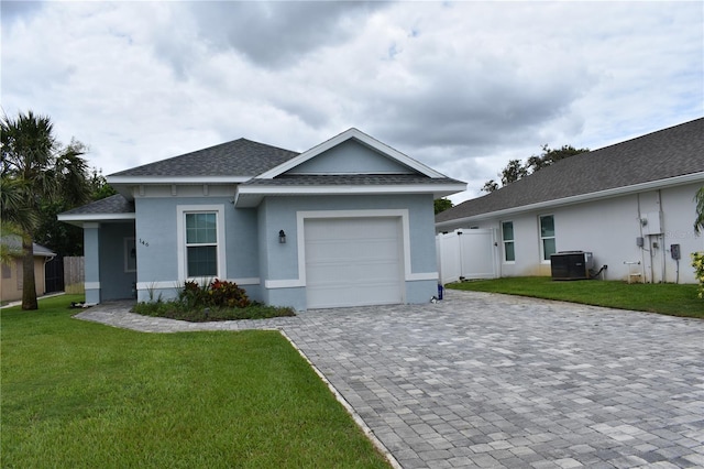 146 Via Madrid Dr, Ormond Beach, FL 32176 - single story home featuring a garage, decorative driveway, roof with shingles, and stucco siding