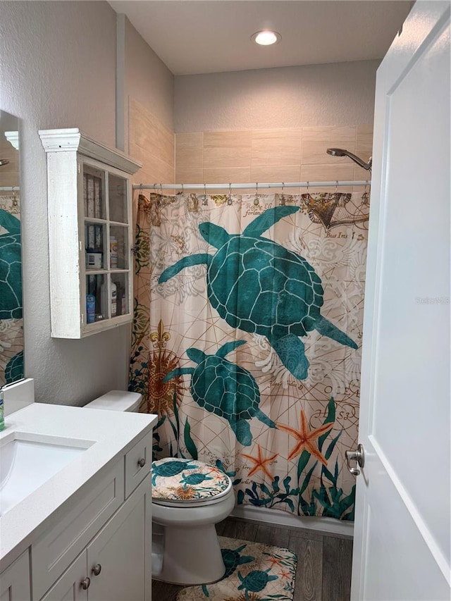 146 Via Madrid Dr, Ormond Beach, FL 32176 - full bathroom with vanity, wood finished floors, a shower with curtain, recessed lighting, and a textured wall