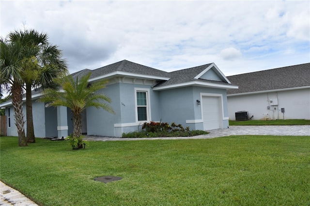 146 Via Madrid Dr, Ormond Beach, FL 32176 - view of front of house featuring a garage, a shingled roof, a front yard, and stucco siding