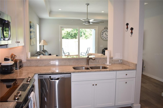 146 Via Madrid Dr, Ormond Beach, FL 32176 - kitchen with appliances with stainless steel finishes, light stone countertops, white cabinets, ceiling fan, and recessed lighting