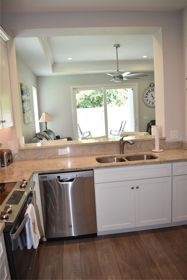 146 Via Madrid Dr, Ormond Beach, FL 32176 - kitchen with appliances with stainless steel finishes, light stone counters, dark wood-style flooring, white cabinets, and recessed lighting