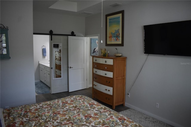 146 Via Madrid Dr, Ormond Beach, FL 32176 - bedroom with a barn door and wood finished floors