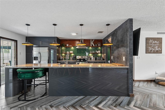 8 White Horse Ln, Palm Coast, FL 32164 - bar with appliances with stainless steel finishes, a textured ceiling, decorative backsplash, exhaust hood, and decorative light fixtures