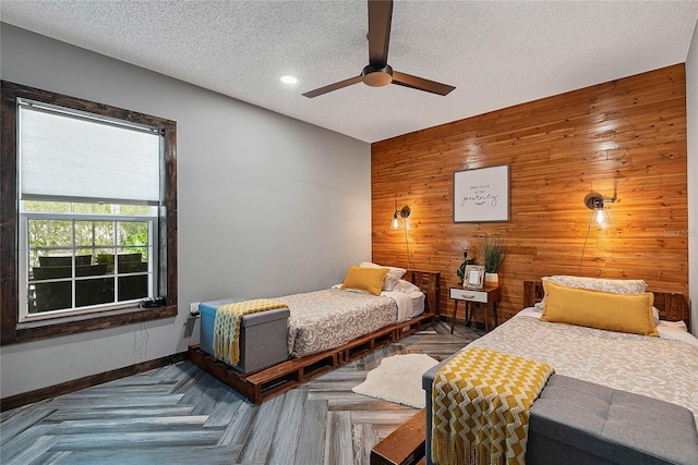 8 White Horse Ln, Palm Coast, FL 32164 - bedroom with wood walls, an accent wall, ceiling fan, a textured ceiling, and recessed lighting
