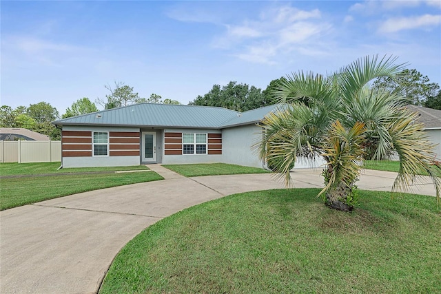 8 White Horse Ln, Palm Coast, FL 32164 - view of front facade with curved driveway, a metal roof, and stucco siding