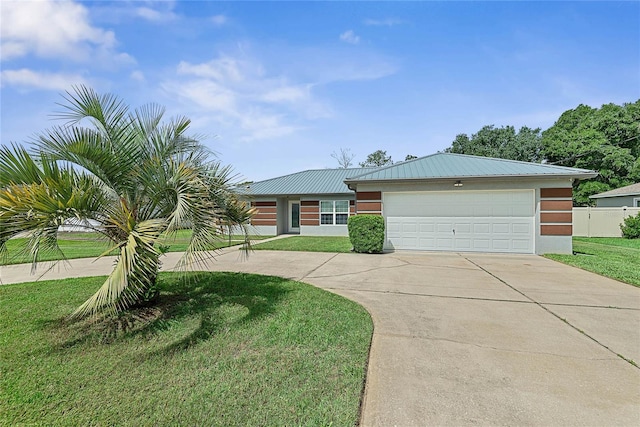 8 White Horse Ln, Palm Coast, FL 32164 - view of front facade with concrete driveway, a front lawn, an attached garage, a metal roof, and stucco siding