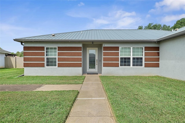 8 White Horse Ln, Palm Coast, FL 32164 - view of front of house featuring a metal roof and stucco siding