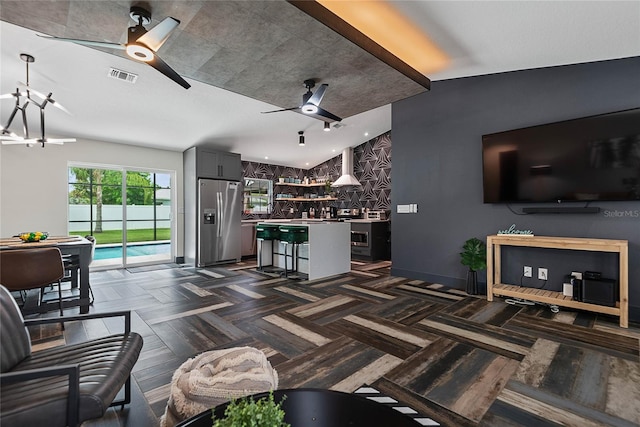 66 Randolph Dr, Palm Coast, FL 32164 - living area featuring a ceiling fan and a dry bar