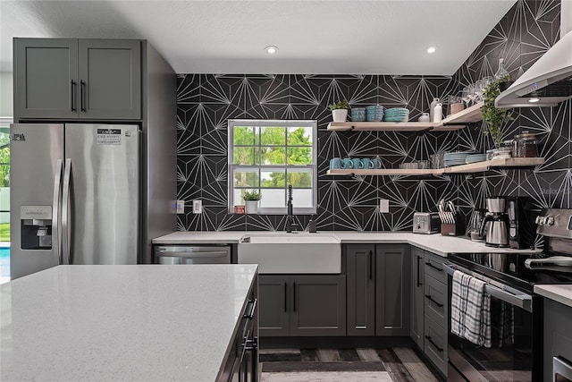 66 Randolph Dr, Palm Coast, FL 32164 - kitchen featuring stainless steel appliances, open shelves, wall chimney exhaust hood, gray cabinetry, and recessed lighting