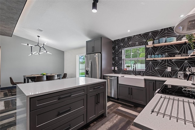 66 Randolph Dr, Palm Coast, FL 32164 - kitchen with appliances with stainless steel finishes, open shelves, a chandelier, a kitchen island, and hanging light fixtures