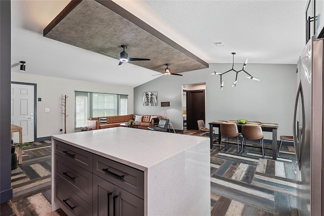 66 Randolph Dr, Palm Coast, FL 32164 - kitchen featuring vaulted ceiling, light countertops, freestanding refrigerator, open floor plan, and pendant lighting