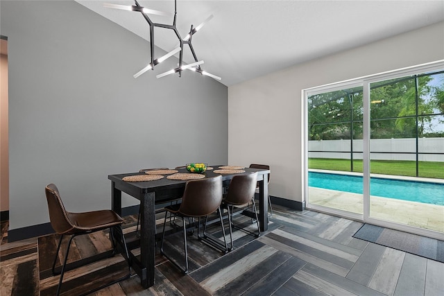 66 Randolph Dr, Palm Coast, FL 32164 - dining space with lofted ceiling, dark wood-type flooring, and a chandelier