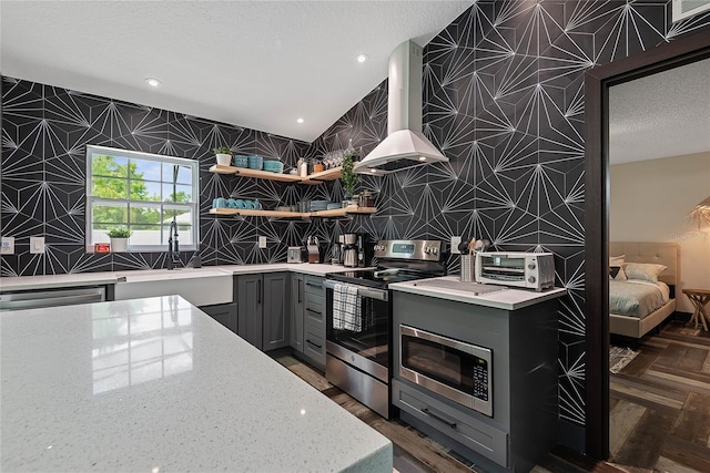 66 Randolph Dr, Palm Coast, FL 32164 - kitchen featuring stainless steel appliances, island exhaust hood, gray cabinetry, light stone countertops, and open shelves