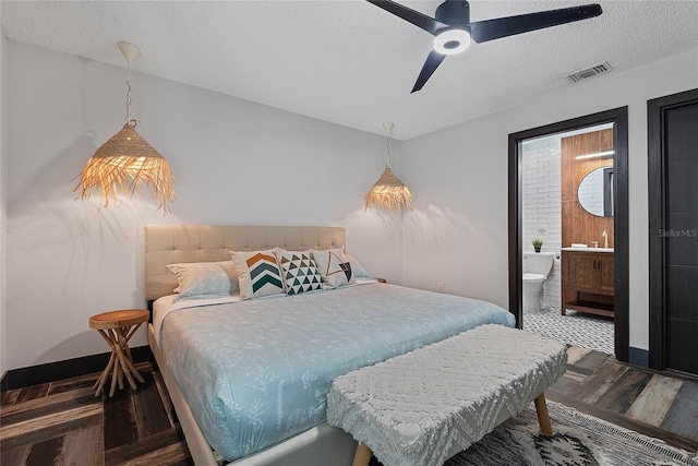 66 Randolph Dr, Palm Coast, FL 32164 - bedroom featuring wood finished floors, ensuite bath, a textured ceiling, and a ceiling fan