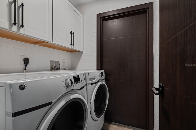 66 Randolph Dr, Palm Coast, FL 32164 - laundry room with washing machine and clothes dryer and cabinet space
