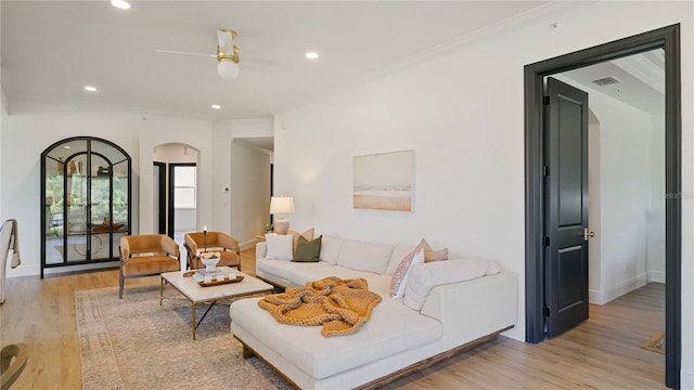 455 Riverfront Dr Unit A101, Palm Coast, FL 32137 - living area featuring arched walkways, light wood-style flooring, crown molding, a ceiling fan, and recessed lighting