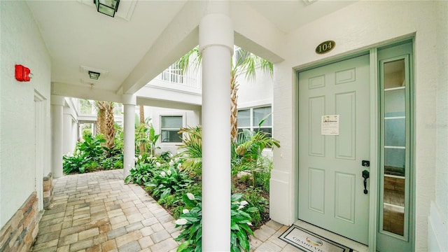455 Riverfront Dr Unit A104, Palm Coast, FL 32137 - property entrance featuring stucco siding and a porch