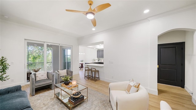 455 Riverfront Dr Unit A203, Palm Coast, FL 32137 - living room featuring arched walkways, ornamental molding, light wood-style floors, ceiling fan, and recessed lighting