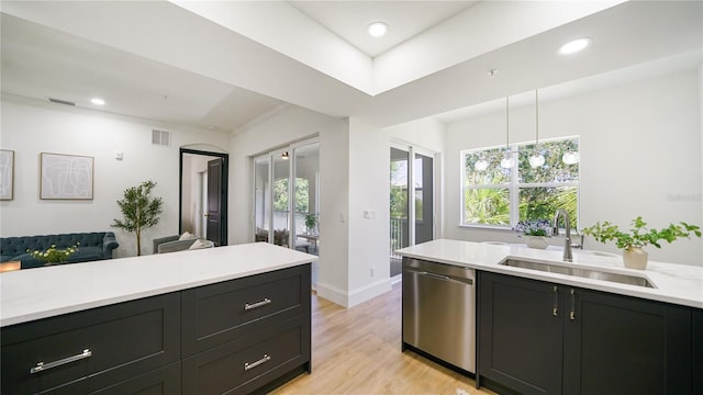 455 Riverfront Dr Unit A203, Palm Coast, FL 32137 - kitchen featuring stainless steel dishwasher, light countertops, light wood-type flooring, dark cabinetry, and recessed lighting