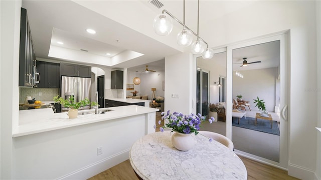 455 Riverfront Dr Unit A203, Palm Coast, FL 32137 - kitchen with stainless steel refrigerator with ice dispenser, a ceiling fan, a peninsula, light wood-style floors, and recessed lighting