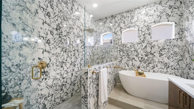 455 Riverfront Dr Unit A203, Palm Coast, FL 32137 - full bathroom with a marble finish shower, a freestanding tub, vanity, and recessed lighting