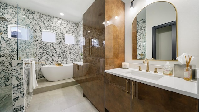 455 Riverfront Dr Unit A203, Palm Coast, FL 32137 - full bath featuring vanity, a soaking tub, tile patterned floors, a walk in shower, and tile walls