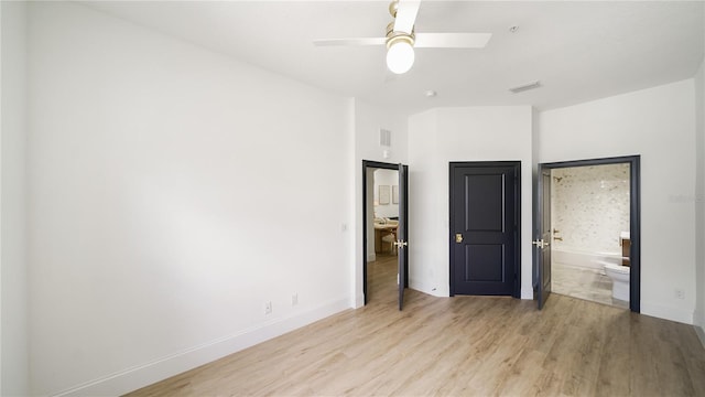 455 Riverfront Dr Unit A203, Palm Coast, FL 32137 - unfurnished bedroom featuring light wood-style flooring, ensuite bathroom, and a ceiling fan