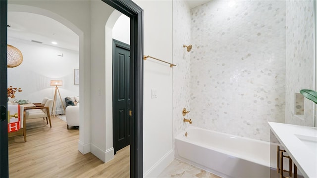 455 Riverfront Dr Unit A203, Palm Coast, FL 32137 - bathroom with ensuite bath, wood finished floors, vanity, and washtub / shower combination