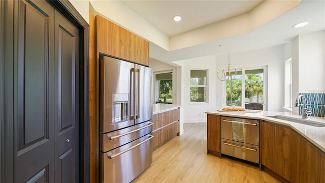 455 Riverfront Dr Unit A204, Palm Coast, FL 32137 - kitchen featuring stainless steel appliances, brown cabinets, modern cabinets, light wood finished floors, and recessed lighting