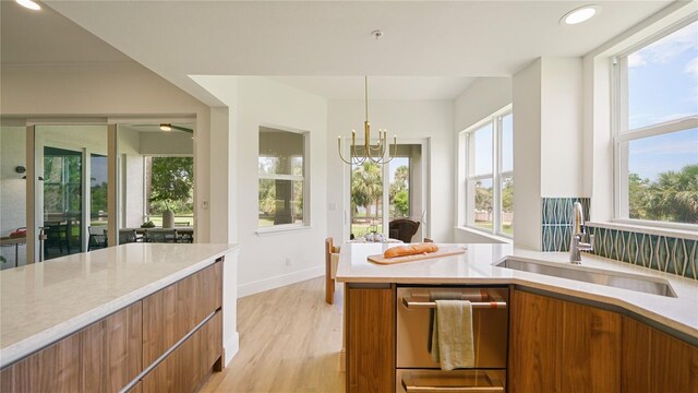 455 Riverfront Dr Unit A204, Palm Coast, FL 32137 - kitchen with brown cabinetry, modern cabinets, light countertops, healthy amount of natural light, and recessed lighting