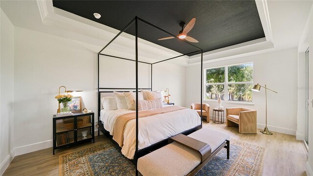 455 Riverfront Dr Unit A204, Palm Coast, FL 32137 - bedroom with a raised ceiling, wood finished floors, and ceiling fan