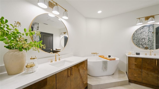 455 Riverfront Dr Unit A204, Palm Coast, FL 32137 - full bathroom featuring two vanities, tile patterned floors, a freestanding tub, and recessed lighting