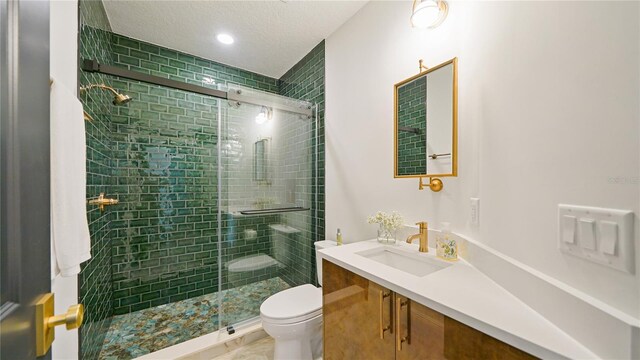 455 Riverfront Dr Unit A204, Palm Coast, FL 32137 - full bath with vanity, a shower stall, a textured ceiling, and recessed lighting