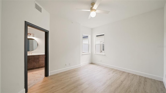 455 Riverfront Dr Unit A204, Palm Coast, FL 32137 - unfurnished bedroom featuring light wood-type flooring, ensuite bathroom, and a ceiling fan