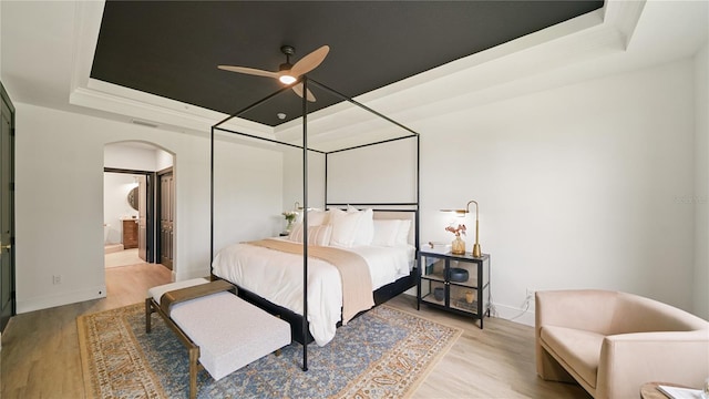 455 Riverfront Dr Unit A301, Palm Coast, FL 32137 - bedroom featuring a tray ceiling, arched walkways, and light wood-style floors