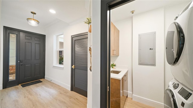 455 Riverfront Dr Unit A301, Palm Coast, FL 32137 - entrance foyer featuring stacked washer and clothes dryer, electric panel, light wood-style floors, ornamental molding, and recessed lighting