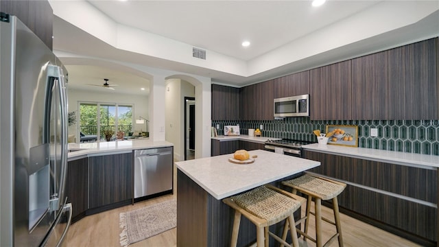 455 Riverfront Dr Unit A302, Palm Coast, FL 32137 - kitchen featuring stainless steel appliances, modern cabinets, light countertops, a ceiling fan, and a breakfast bar area