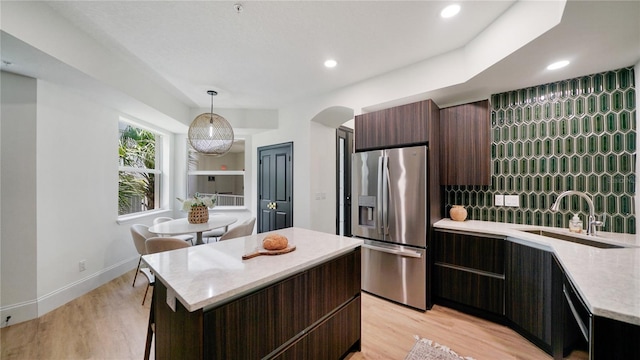 455 Riverfront Dr Unit A302, Palm Coast, FL 32137 - kitchen featuring stainless steel fridge with ice dispenser, modern cabinets, light wood-style floors, a center island, and recessed lighting