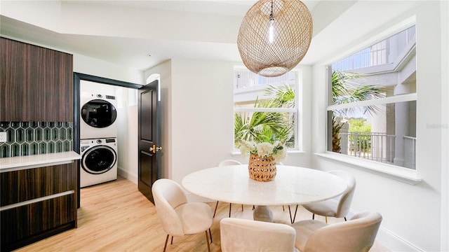 455 Riverfront Dr Unit A302, Palm Coast, FL 32137 - dining space featuring estacked washer and dryer, plenty of natural light, and light wood finished floors