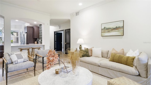455 Riverfront Dr Unit A302, Palm Coast, FL 32137 - living area featuring ornamental molding, arched walkways, wood finished floors, and recessed lighting