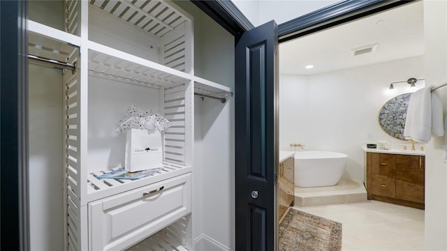 455 Riverfront Dr Unit A302, Palm Coast, FL 32137 - bathroom with vanity, a freestanding tub, and tile patterned floors