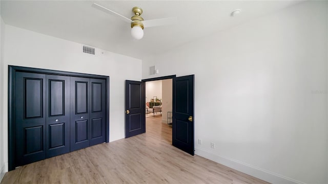 455 Riverfront Dr Unit A302, Palm Coast, FL 32137 - unfurnished bedroom featuring light wood-style flooring, a ceiling fan, and a closet
