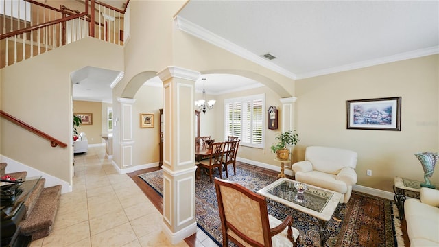 30 Cortes Ct, Palm Coast, FL 32137 - living room featuring arched walkways, ornate columns, crown molding, stairway, and a chandelier