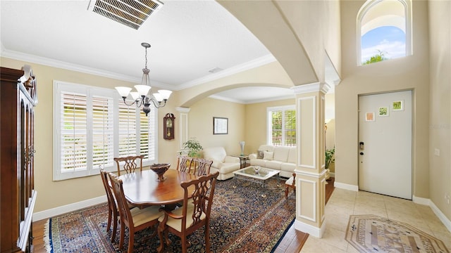 30 Cortes Ct, Palm Coast, FL 32137 - dining room featuring ornate columns, arched walkways, ornamental molding, and a chandelier
