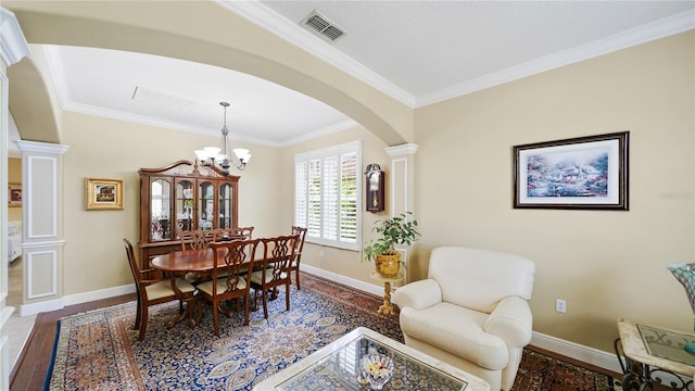 30 Cortes Ct, Palm Coast, FL 32137 - dining space featuring arched walkways, ornamental molding, decorative columns, a chandelier, and wood finished floors