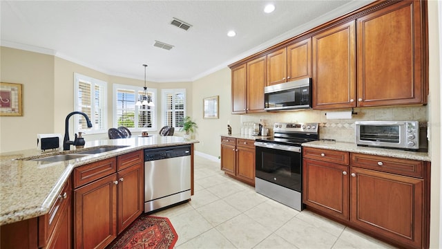 30 Cortes Ct, Palm Coast, FL 32137 - kitchen with stainless steel appliances, ornamental molding, backsplash, light stone countertops, and light tile patterned floors